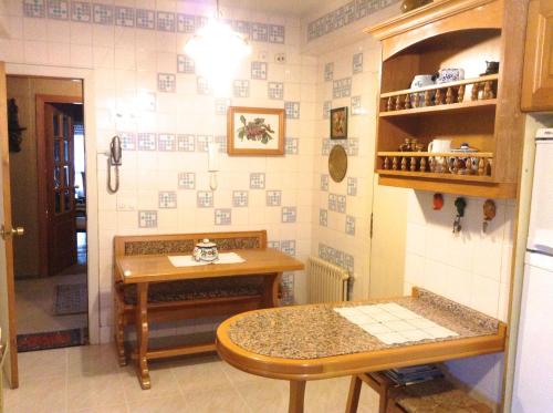 a kitchen with a table and a small table in a room at APARTAMENTO 10 PISO VISTAS AL MAR in Ferrol