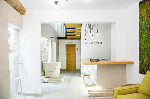a living room with a yellow chair and a counter at MEMENTO B&B Piran in Piran