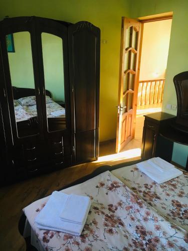 a bedroom with a dresser with towels on a bed at Old House in Akhaltsikhe