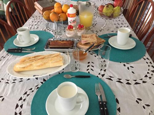 a table with plates of food and cups of coffee at Granados in Asuncion