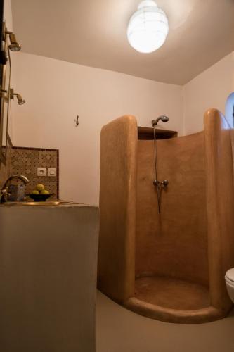 a bathroom with a bath tub with a sink at Riad SASHA in Marrakesh