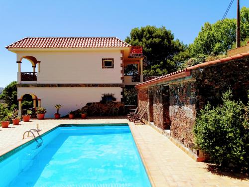 a villa with a swimming pool in front of a house at *****Finca Bella Vista in Arucas