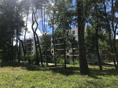 an apartment building in the middle of a forest at Family & Business Sauna Apartments No2 Leśny nad Zalewem Cedzyna - 2 Bedroom with Private Sauna, Bath with Hydromassage, Terrace, Parking, Catering Options in Kielce