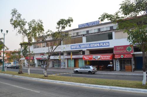 a car parked in front of a building on a street at Hotel Suites Ixtapa Plaza in Ixtapa