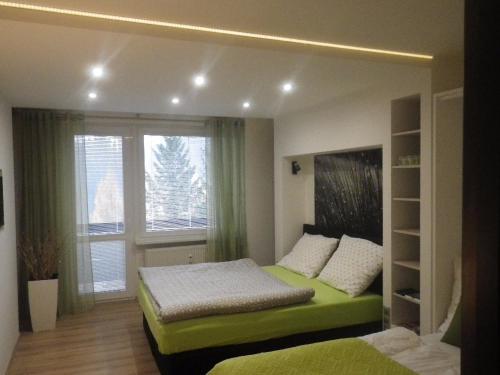 Postel nebo postele na pokoji v ubytování HARMONY Apartment