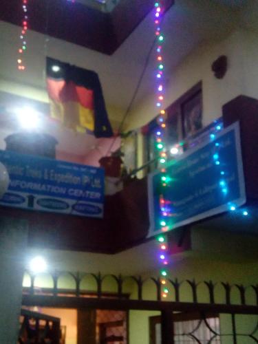 a group of signs on a wall with christmas lights at Everest Home Stay Apartment in Pātan