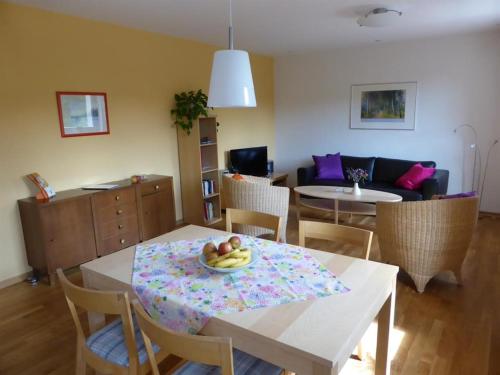 a living room with a table with a bowl of fruit on it at Irreler Mühle Ferienwohnungen und Ferienhäuser in Irrel