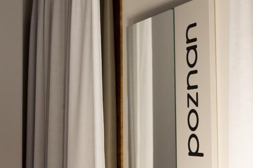 a white curtain next to a window with a sign at Crystal Luxury House in Fiume Veneto