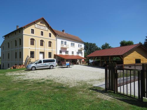 a car parked in front of a building at Mill House Apartment and Camping in Ljutomer