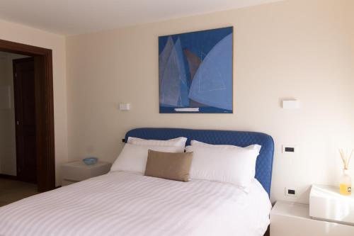 a bedroom with a bed with a blue head board at Crystal Luxury House in Fiume Veneto