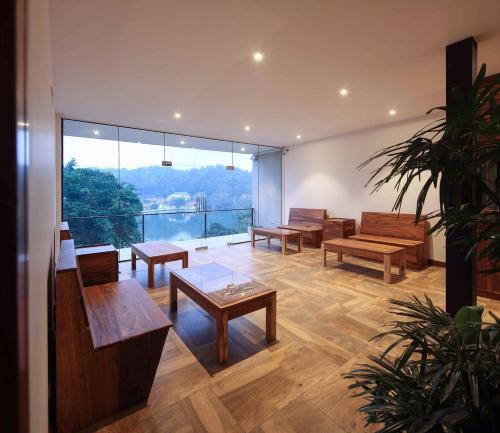 a room with benches and tables and a large window at Lakewood Residence in Kandy
