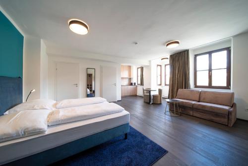a large bedroom with a bed and a couch at Blackhome Innsbruck Boutique I contactless check-in in Innsbruck