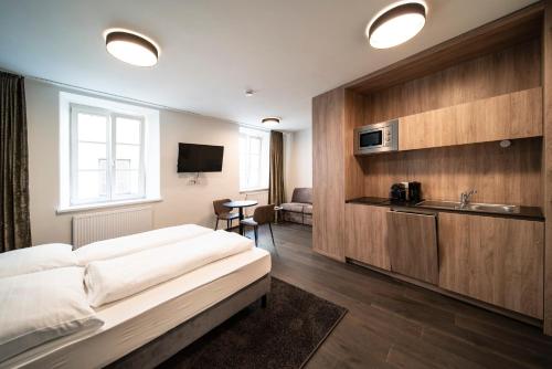 a hotel room with a bed and a sink at Blackhome Innsbruck Boutique I contactless check-in in Innsbruck