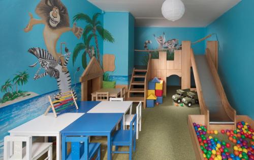 a classroom with a play room with a monkey mural on the wall at Pinia Hotel & Resort in Špindlerův Mlýn