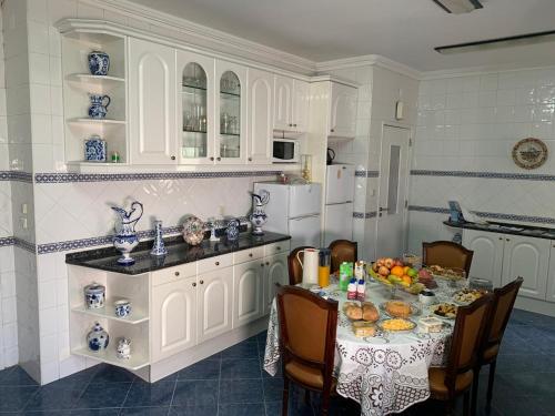a kitchen with a table with food on it at Lar dois coracões in Lisbon