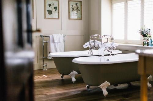 
a bath tub sitting next to a sink in a bathroom at The Alverton in Truro

