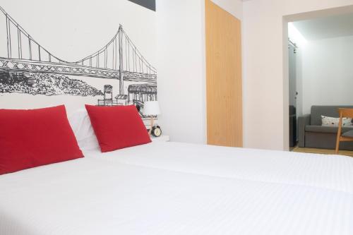 a hotel room with a large bed and a large window at Páteo Saudade Lofts in Lisbon