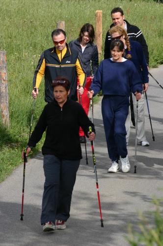 a group of people walking down a walkway with poles at Pension Staldacher in Hasliberg