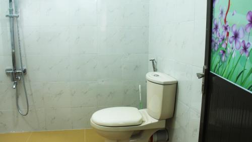 a bathroom with a toilet and a shower at Grand Villa in Anuradhapura