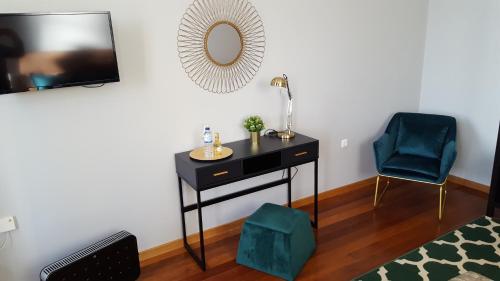 a room with a table and a chair and a mirror at Cool Guesthouse in Porto