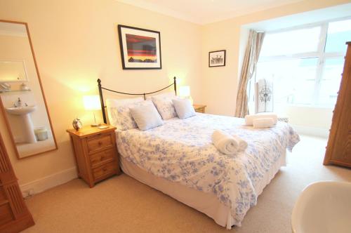 a bedroom with a large bed and a window at Pip's Corner in Lynton