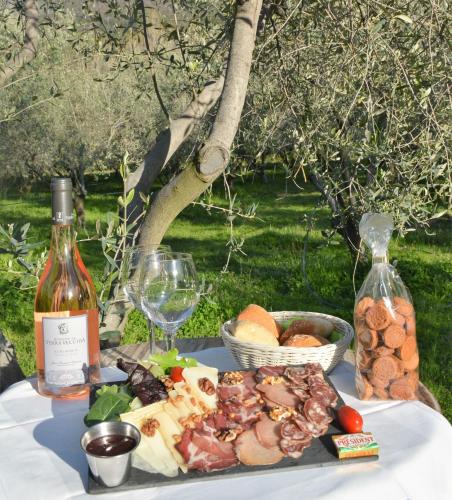 a table with a plate of food and a bottle of wine at Camping Le Sagone in Sagone
