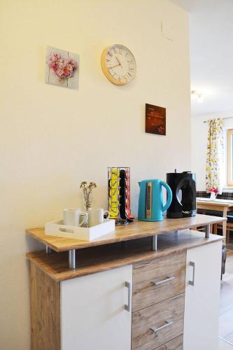 a counter top with a clock on a wall at Niederstallnhof in Sankt Johann im Pongau