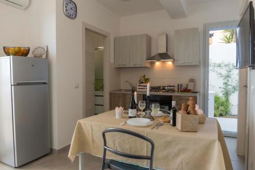a kitchen with a table with a table cloth on it at MareinSicilia: Talia Residence in Sampieri