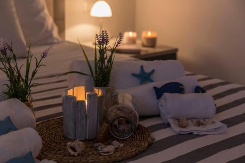 a hotel room with a bed with towels and candles at MareinSicilia: Talia Residence in Sampieri
