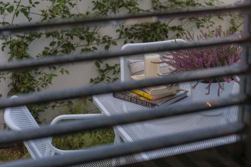 a stack of chairs with books on them at MareinSicilia: Talia Residence in Sampieri