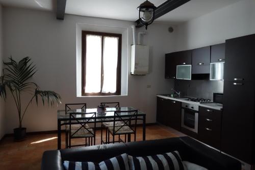 a living room with a table and a kitchen at Agriturismo Molino Nuovo in Castel San Pietro Terme