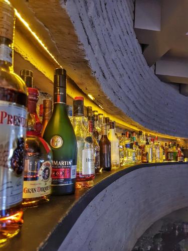 a bar filled with lots of bottles of alcohol at Hotel Palacio Azteca Tijuana, Trademark by Wyndham in Tijuana
