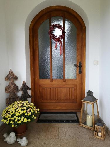 a wooden door with a wreath on it at Vornbichlhof in Fieberbrunn