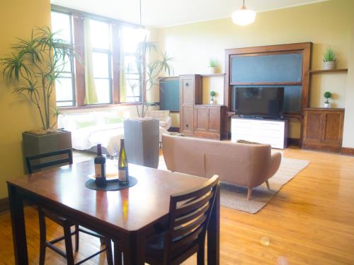 a living room with a couch and a table at School 31 Lofts in Rochester