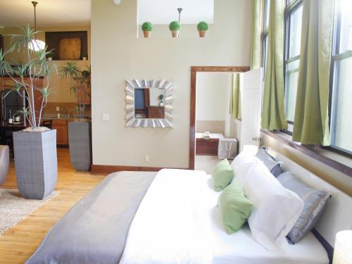 a bedroom with a large bed and a mirror at School 31 Lofts in Rochester