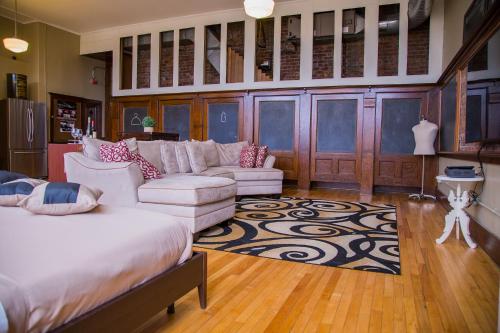 a living room with a bed and a couch at School 31 Lofts in Rochester