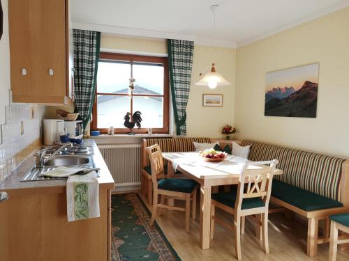 a kitchen and dining room with a table and chairs at Vornbichlhof in Fieberbrunn