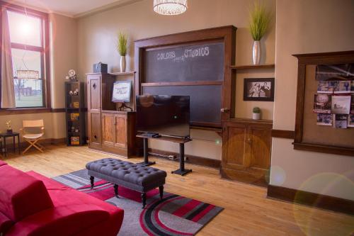 a living room with a chalkboard on the wall at School 31 Lofts in Rochester
