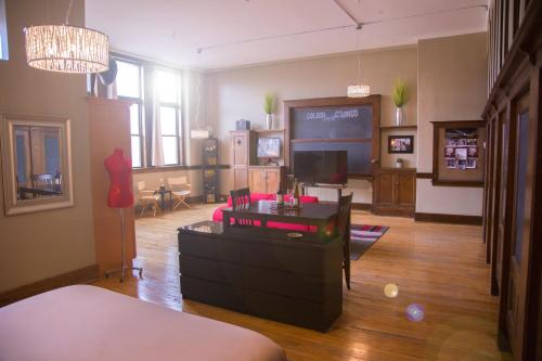 a living room with a couch and a tv at School 31 Lofts in Rochester