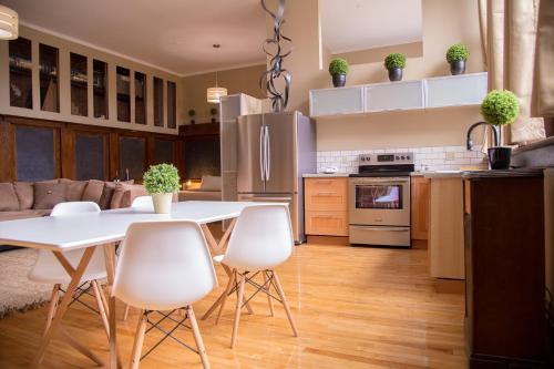 a kitchen and living room with a white table and chairs at School 31 Lofts in Rochester
