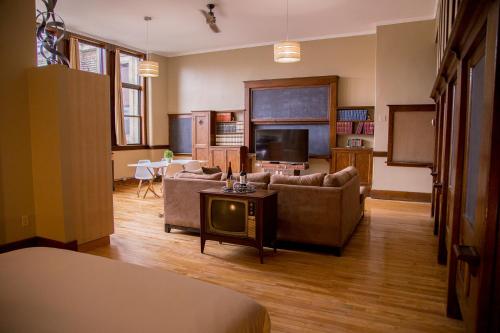 a living room with a couch and a tv at School 31 Lofts in Rochester