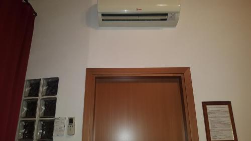 a door with a air conditioner above it at Hotel Ristorante da Righetto in Campagnano di Roma
