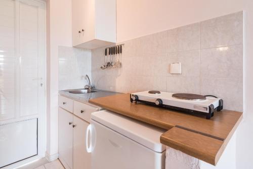 a kitchen with a stove on top of a counter at Yiota Studios in Alykes