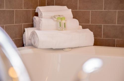 a pile of towels sitting on top of a bathroom sink at School 31 Lofts in Rochester