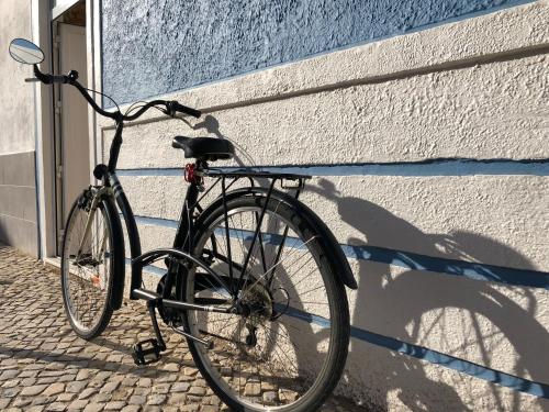 a bike parked against a wall next to a building at Home Sweet Home VRSA in Vila Real de Santo António