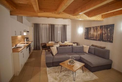 a living room with a couch and a table at Apart Waldblick in Oetz
