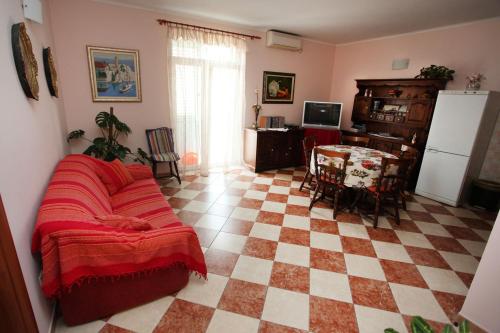 a living room with a couch and a checkered floor at Split Apartments Peric in Split