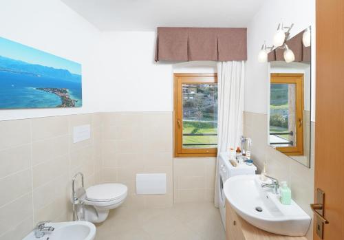 a bathroom with a toilet and a sink at Villa delle Querce in Tremosine Sul Garda