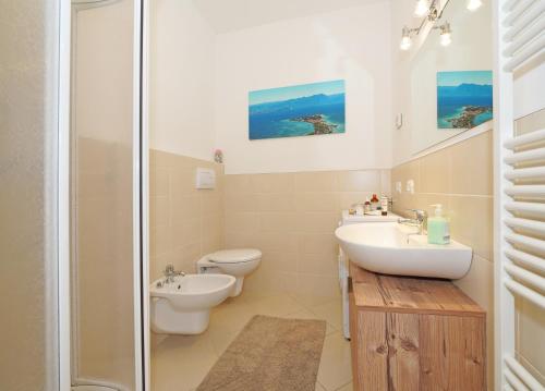 a bathroom with a toilet and a sink and a shower at Villa delle Querce in Tremosine Sul Garda