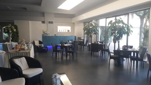 un comedor con mesas y sillas y un restaurante en Il Portico Luxury B&B, en Cassano delle Murge